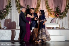 Indian bride and groom being blessed by grooms parents. Indian bride and groom being blessed by grooms parents.
