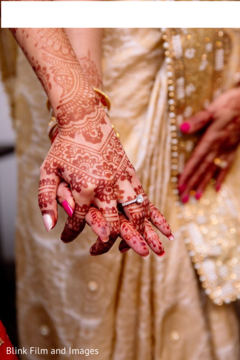 Maharani's henna stained hand holding an Indian relative's hand Maharani's henna stained hand holding an Indian relative's hand