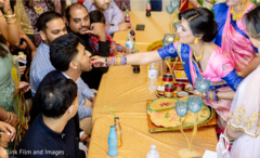 Indian groom being fed by an Indian relative Indian groom being fed by an Indian relative