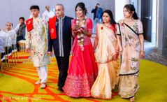 Indian bride entering the hall escorted by her Indian relatives Indian bride entering the hall escorted by her Indian relatives