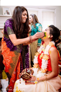 Indian relative applying tumeric paste to Maharani's face Indian relative applying tumeric paste to Maharani's face