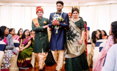 Indian groom walking down the aisle escorted by Indian relatives Indian groom walking down the aisle escorted by Indian relatives