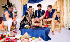 Indian groom and Indian relatives making offerings to the sacred fire Indian groom and Indian relatives making offerings to the sacred fire