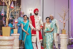 Indian groom walking down the aisle escorted by his Indian relatives Indian groom walking down the aisle escorted by his Indian relatives