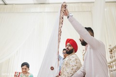 A veil is placed to hide the Indian groom A veil is placed to hide the Indian groom