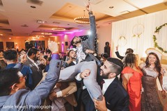 Indian groomsmen carrying each other during the party Indian groomsmen carrying each other during the party