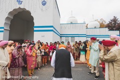 Indian groom and Indian relatives saying a prayer outside the temple Indian groom and Indian relatives saying a prayer outside the temple