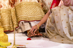 Maharai putting ring on his Indian groom toe. Maharai putting ring on his Indian groom toe.