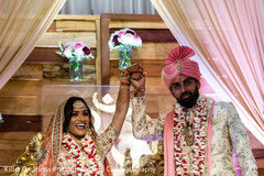 Indian couple raising hands after getting married. Indian couple raising hands after getting married.