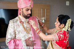 Indian groom being assisted by Indian relative. Indian groom being assisted by Indian relative.