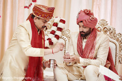 Indian groom receiving gift from relative. Indian groom receiving gift from relative.