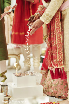 Indian couple tossing rice for agni ritual. Indian couple tossing rice for agni ritual.