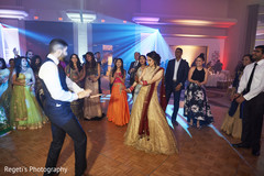 Indian bride and her groom dancing during the reception party. Indian bride and her groom dancing during the reception party.