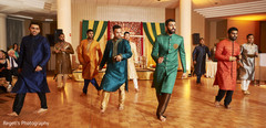 Indian groom and his groomsmen performing during the sangeet. Indian groom and his groomsmen performing during the sangeet.