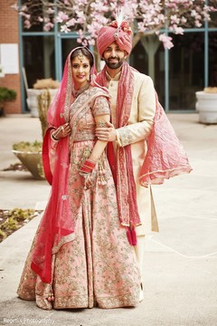 Maharani in pink saree with her groom wearing a pink turban. Maharani in pink saree with her groom wearing a pink turban.