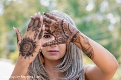 Indian bride showing off her henna stained hands Indian bride showing off her henna stained hands