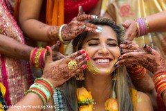Indian relatives applying tumeric to Maharani's face Indian relatives applying tumeric to Maharani's face