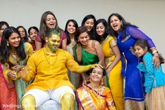 Indian groom covered in tumeric paste Indian groom covered in tumeric paste