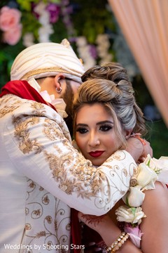 Indian groom putting a necklace on his Maharani Indian groom putting a necklace on his Maharani