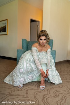 Indian bride putting on her shoes Indian bride putting on her shoes