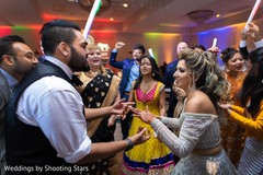 Indian newlyweds dancing in the middle of their Indian relatives Indian newlyweds dancing in the middle of their Indian relatives