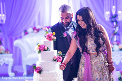 Indian Bride and Groom at the reception with wedding cake Indian Bride and Groom at the reception with wedding cake