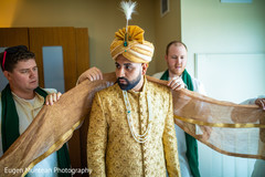 Raja getting his yellow and golden wedding ceremony outfit. Raja getting his yellow and golden wedding ceremony outfit.