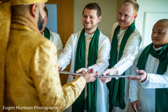 Indian groomsmen giving the talwar to groom. Indian groomsmen giving the talwar to groom.