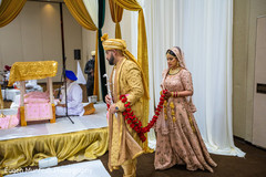 Indian bride following the groom at the sevensteps ritual. Indian bride following the groom at the sevensteps ritual.