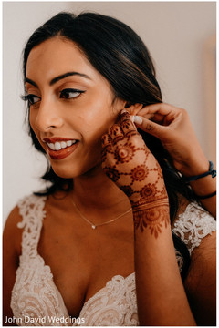 Indian bride getting her earrings on. Indian bride getting her earrings on.