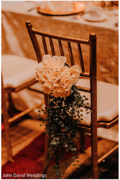 Indian wedding reception chair ivory roses decoration. Indian wedding reception chair ivory roses decoration.