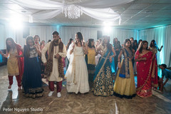 Indian bride dancing with guests at reception Indian bride dancing with guests at reception