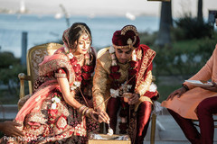 Indian couple pouring offerings to Agni. Indian couple pouring offerings to Agni.