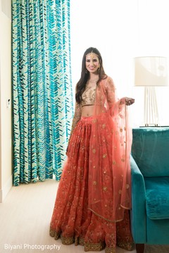 Indian bride on her coral and golden colored lehenga. Indian bride on her coral and golden colored lehenga.