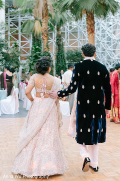 Indina couple walking on sangeet dancefloor. Indina couple walking on sangeet dancefloor.
