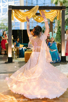 Indina bride dancing in her pink lehenga at Sangeet. Indina bride dancing in her pink lehenga at Sangeet.