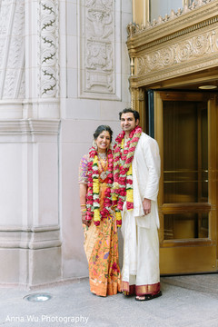 Indina bride and groom possing with their red and yellow garlands. Indina bride and groom possing with their red and yellow garlands.