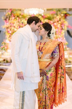 Indian bride in her orange saree with groom. Indian bride in her orange saree with groom.