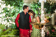 Indian couple posing outdoors in their sangeet outfits. Indian couple posing outdoors in their sangeet outfits.