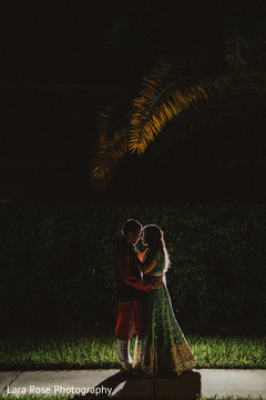 Indian couple posing outdoors for sangeet photo session. Indian couple posing outdoors for sangeet photo session.