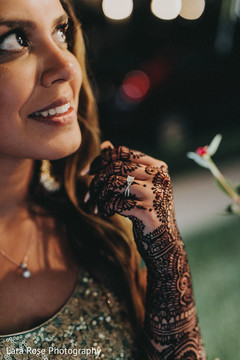 Indian bride with her white gold ring in her mehndi decorated hand. Indian bride with her white gold ring in her mehndi decorated hand.