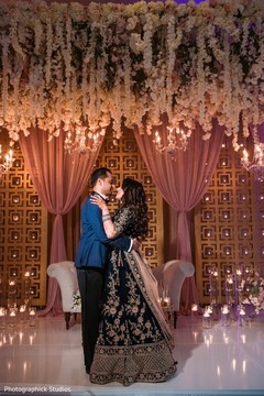 Indian bride and groom posing at reception stage. Indian bride and groom posing at reception stage.