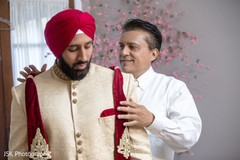 Indian groom getting his ceremony outfit on. Indian groom getting his ceremony outfit on.