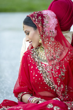 Indian bride wearing her red ghoonghat. Indian bride wearing her red ghoonghat.