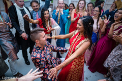 Cheerful Indian couple dancing during pre-wedding events Cheerful Indian couple dancing during pre-wedding events