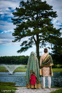 Bride and groom looking to the horizon during outdoor photoshoot Bride and groom looking to the horizon during outdoor photoshoot