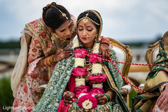 Lovely bride wearing a garland necklace during the wedding ceremony Lovely bride wearing a garland necklace during the wedding ceremony