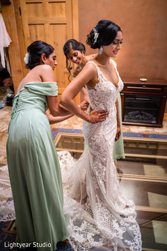 Bride getting dressed in her gorgeous white gown. Bride getting dressed in her gorgeous white gown.