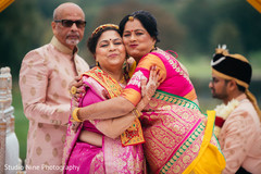 Indian relatives hug at wedding ceremony. Indian relatives hug at wedding ceremony.