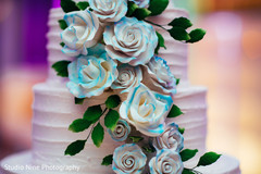 White and blue roses on indian wedding cake decoration. White and blue roses on indian wedding cake decoration.